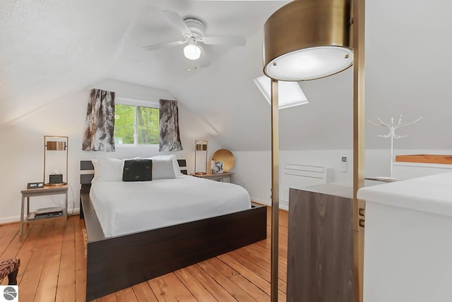 10092 S Elm St, Traverse City, MI 49684 - bedroom with light wood-type flooring, vaulted ceiling, and a ceiling fan