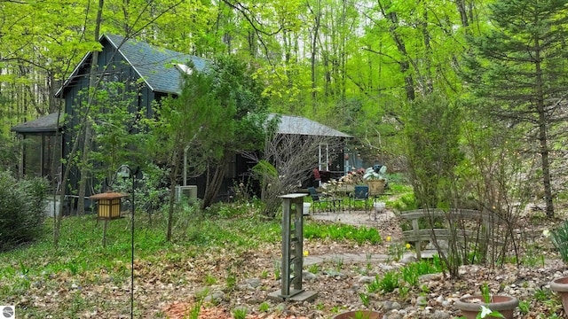 10092 S Elm St, Traverse City, MI 49684 - view of yard featuring a wooded view