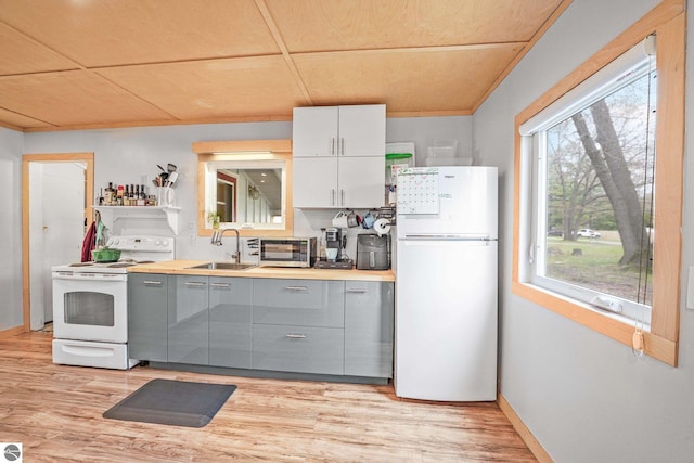 1615 Pine Dr, Traverse City, MI 49686 - kitchen with white appliances, a sink, gray cabinets, and light wood-style flooring