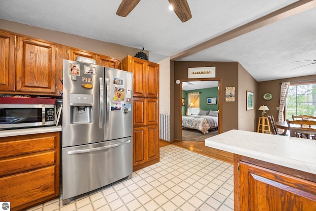 5206 S Riverview Dr, Lake City, MI 49651 - kitchen with stainless steel appliances, ceiling fan, light countertops, brown cabinets, and a textured ceiling