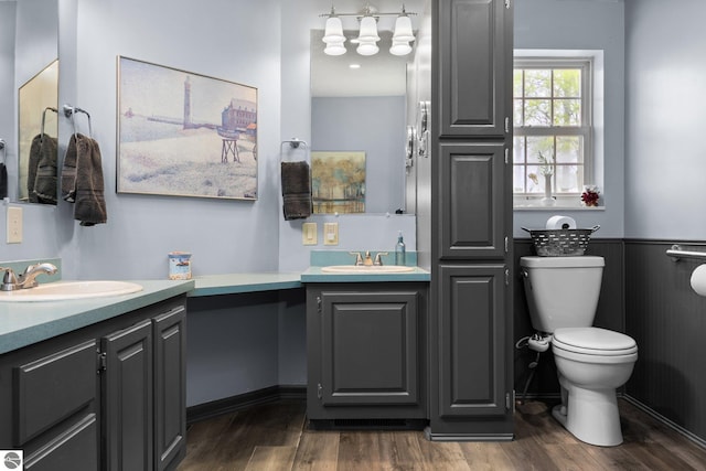 5206 S Riverview Dr, Lake City, MI 49651 - full bath with wood finished floors, two vanities, and toilet
