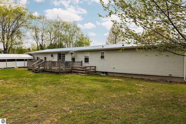 5206 S Riverview Dr, Lake City, MI 49651 - rear view of house featuring a wooden deck, a yard, and metal roof