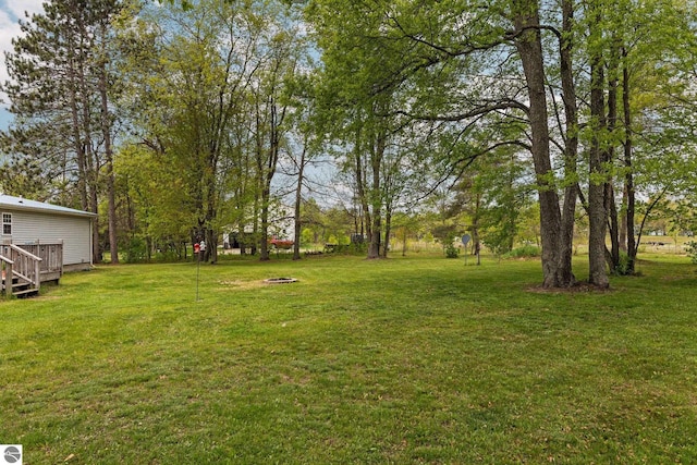 5206 S Riverview Dr, Lake City, MI 49651 - view of grassy yard featuring a wooden deck