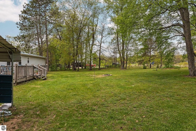 5206 S Riverview Dr, Lake City, MI 49651 - view of grassy yard featuring a wooden deck