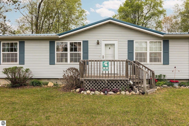 5206 S Riverview Dr, Lake City, MI 49651 - ranch-style home with a front lawn and metal roof