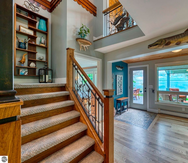 6433 S W Bayshore Dr, Traverse City, MI 49684 - stairs with wood finished floors and baseboard heating