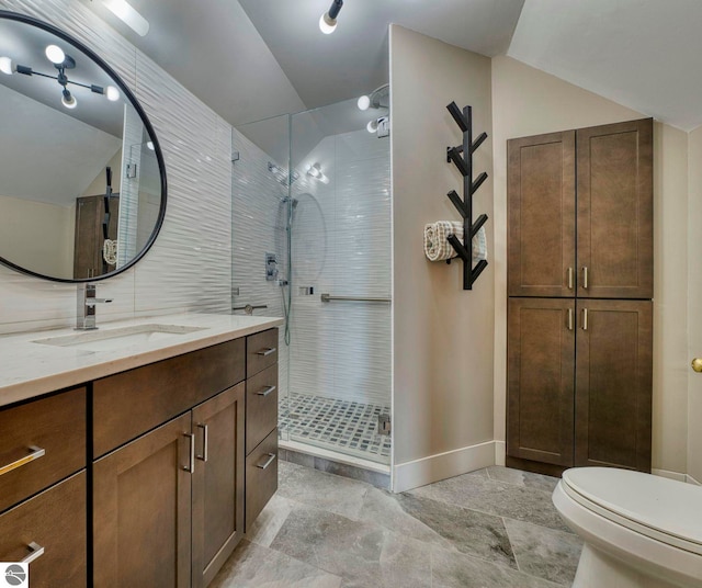 6433 S W Bayshore Dr, Traverse City, MI 49684 - bathroom featuring a shower stall, vanity, vaulted ceiling, toilet, and baseboards