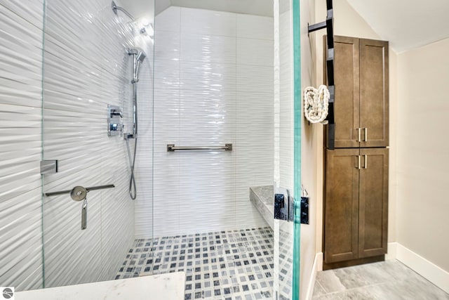 6433 S W Bayshore Dr, Traverse City, MI 49684 - full bathroom with a shower stall, baseboards, and vaulted ceiling
