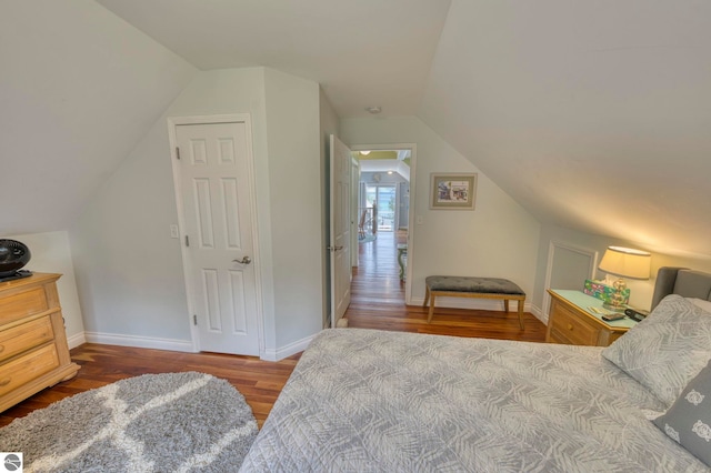 6433 S W Bayshore Dr, Traverse City, MI 49684 - bedroom with wood finished floors, lofted ceiling, and baseboards