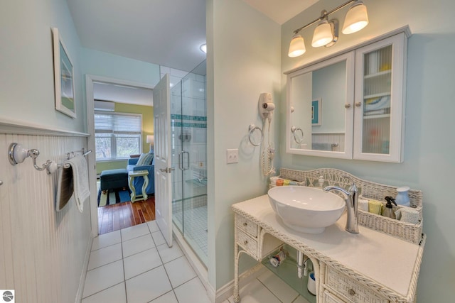 6433 S W Bayshore Dr, Traverse City, MI 49684 - ensuite bathroom with a shower stall, tile patterned flooring, french doors, vanity, and a wall mounted AC