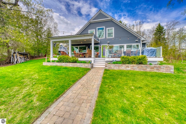 6433 S W Bayshore Dr, Traverse City, MI 49684 - back of property featuring a lawn and a wooden deck