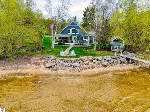 6433 S W Bayshore Dr, Traverse City, MI 49684 - back of property with a porch and a yard