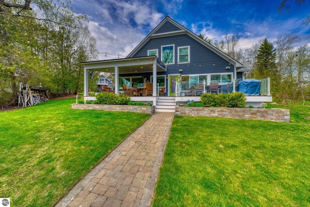 6433 S W Bayshore Dr, Traverse City, MI 49684 - rear view of property featuring a lawn