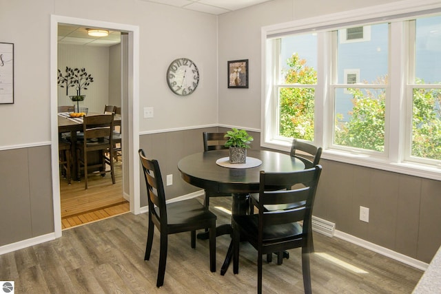 314 Leelanau Ave, Frankfort, MI 49635 - dining area featuring healthy amount of natural light, wood finished floors, and wainscoting