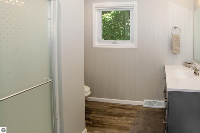 314 Leelanau Ave, Frankfort, MI 49635 - bathroom with wood finished floors, vanity, toilet, and baseboards