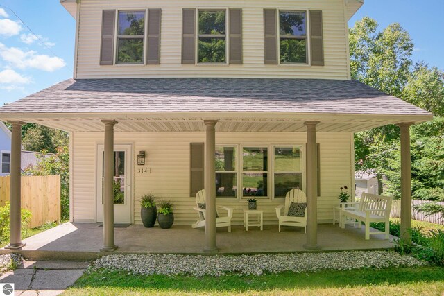314 Leelanau Ave, Frankfort, MI 49635 - rear view of property featuring a porch and a shingled roof