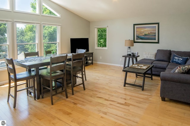 314 Leelanau Ave, Frankfort, MI 49635 - dining room with light wood-style flooring, lofted ceiling, and baseboards