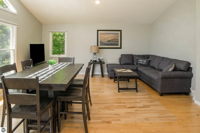 314 Leelanau Ave, Frankfort, MI 49635 - dining area with light wood finished floors, plenty of natural light, lofted ceiling, and baseboards
