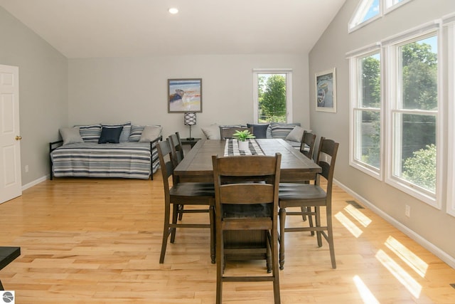 314 Leelanau Ave, Frankfort, MI 49635 - dining area with light wood-style floors, baseboards, recessed lighting, and high vaulted ceiling