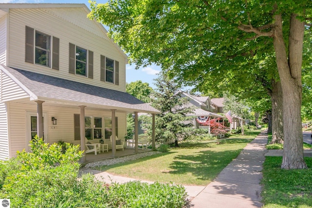314 Leelanau Ave, Frankfort, MI 49635 - view of grassy yard with a porch