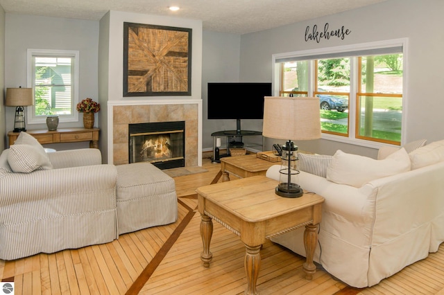 314 Leelanau Ave, Frankfort, MI 49635 - living area with a tiled fireplace, plenty of natural light, and hardwood / wood-style floors