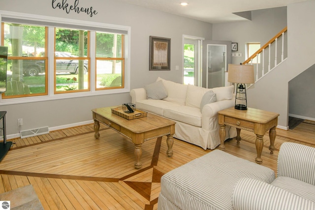 314 Leelanau Ave, Frankfort, MI 49635 - living area featuring wood-type flooring, baseboards, and stairs