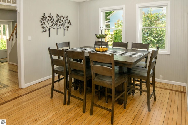314 Leelanau Ave, Frankfort, MI 49635 - dining room with light wood-type flooring, baseboards, and stairs
