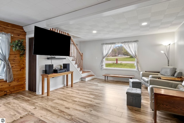 7256 Highland Dr, Beulah, MI 49617 - living room with wood finished floors, stairs, wood walls, and recessed lighting