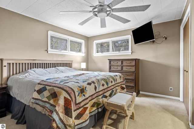 7256 Highland Dr, Beulah, MI 49617 - bedroom featuring light colored carpet, a ceiling fan, and baseboards