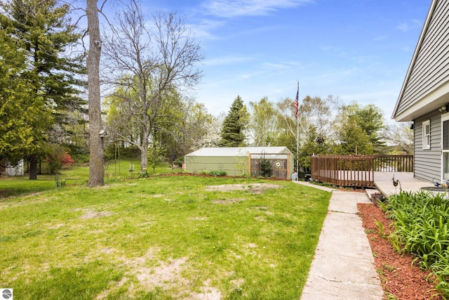 7256 Highland Dr, Beulah, MI 49617 - view of green lawn featuring a wooden deck
