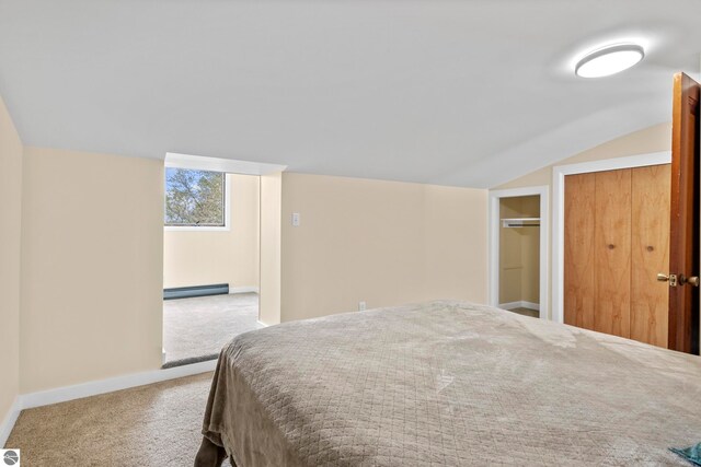 7256 Highland Dr, Beulah, MI 49617 - bedroom featuring baseboard heating, carpet flooring, vaulted ceiling, and baseboards