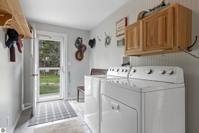 7256 Highland Dr, Beulah, MI 49617 - washroom with cabinet space, washing machine and dryer, baseboards, and light tile patterned floors