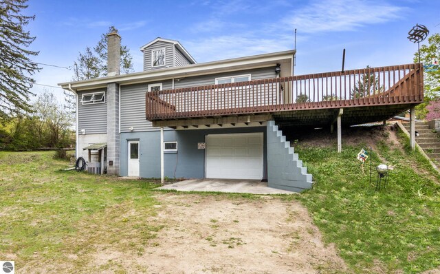 7256 Highland Dr, Beulah, MI 49617 - back of house with dirt driveway, a garage, a deck, and a chimney