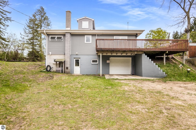 7256 Highland Dr, Beulah, MI 49617 - rear view of property with a deck, a chimney, stairway, an attached garage, and a lawn