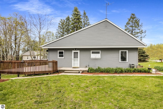 7256 Highland Dr, Beulah, MI 49617 - rear view of house featuring a wooden deck and a lawn