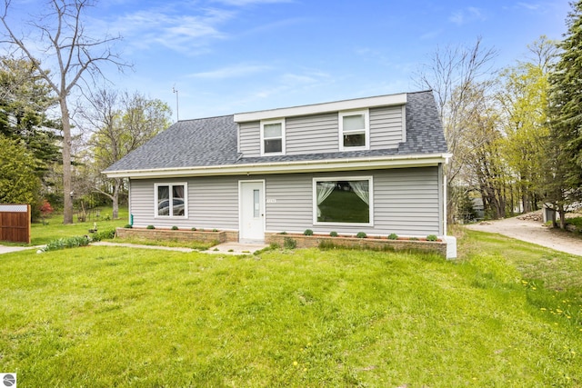 7256 Highland Dr, Beulah, MI 49617 - view of front of property featuring roof with shingles and a front lawn