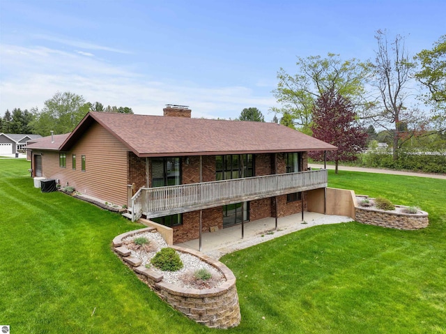129 N Al Moses Rd, Lake City, MI 49651 - back of house with a patio, a yard, a chimney, and brick siding
