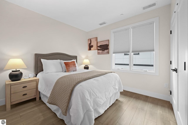 708 Randolph St Unit 204, Traverse City, MI 49684 - bedroom featuring baseboards and wood finished floors