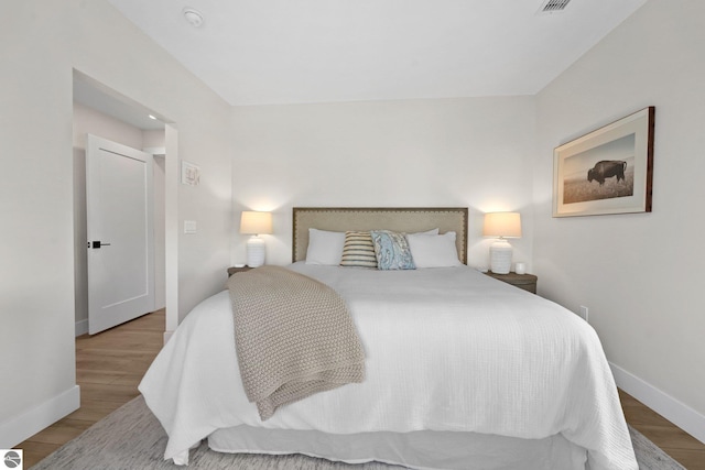 708 Randolph St Unit 204, Traverse City, MI 49684 - bedroom featuring wood finished floors and baseboards