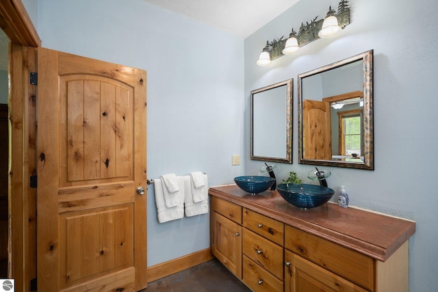 5592 Troon N, Bellaire, MI 49615 - full bath featuring double vanity and baseboards