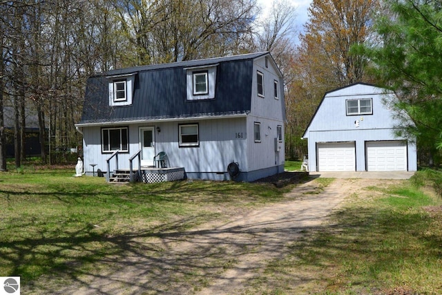 161 Huntinghorn Dr, Roscommon, MI 48653 - dutch colonial featuring a gambrel roof, an outdoor structure, a garage, a front yard, and driveway