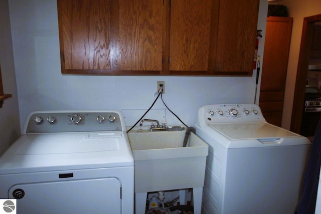161 Huntinghorn Dr, Roscommon, MI 48653 - laundry area with cabinet space and washing machine and clothes dryer