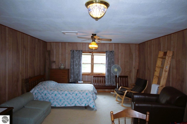 161 Huntinghorn Dr, Roscommon, MI 48653 - carpeted bedroom featuring wooden walls and a ceiling fan