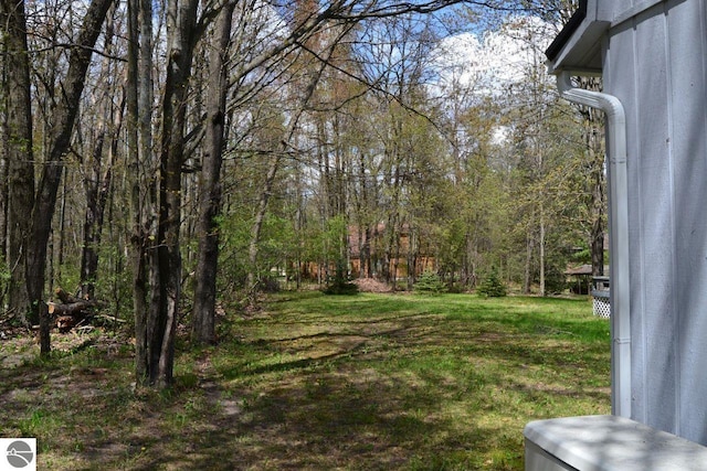 161 Huntinghorn Dr, Roscommon, MI 48653 - view of green lawn featuring a view of trees