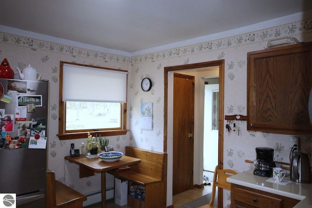 161 Huntinghorn Dr, Roscommon, MI 48653 - dining space featuring wallpapered walls and a baseboard radiator