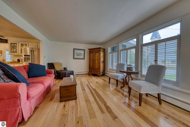 310 W Broadway, Suttons Bay, MI 49682 - living room featuring a baseboard heating unit, light wood-type flooring, and baseboard heating