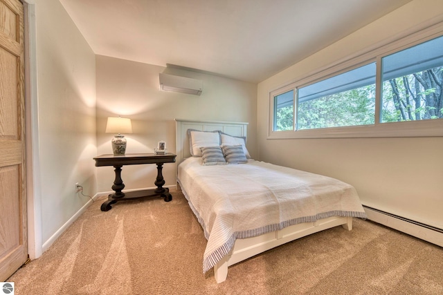 310 W Broadway, Suttons Bay, MI 49682 - carpeted bedroom featuring a wall mounted air conditioner, a baseboard radiator, and baseboards