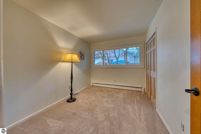 310 W Broadway, Suttons Bay, MI 49682 - unfurnished room featuring a baseboard radiator, carpet flooring, and baseboards