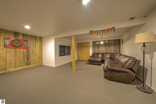 310 W Broadway, Suttons Bay, MI 49682 - living room featuring wooden walls, carpet floors, and baseboards