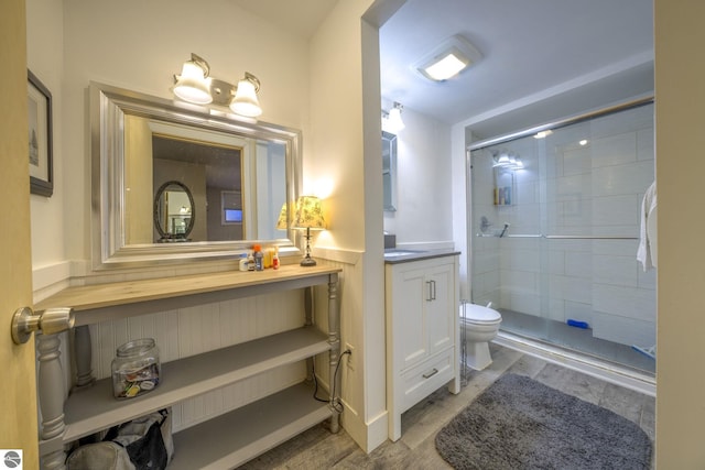 310 W Broadway, Suttons Bay, MI 49682 - full bath with vanity, wood finished floors, a shower stall, toilet, and a wainscoted wall